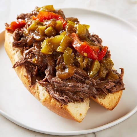A close-up of a delicious Italian Beef Sandwich, showcasing the succulent beef and crusty roll.