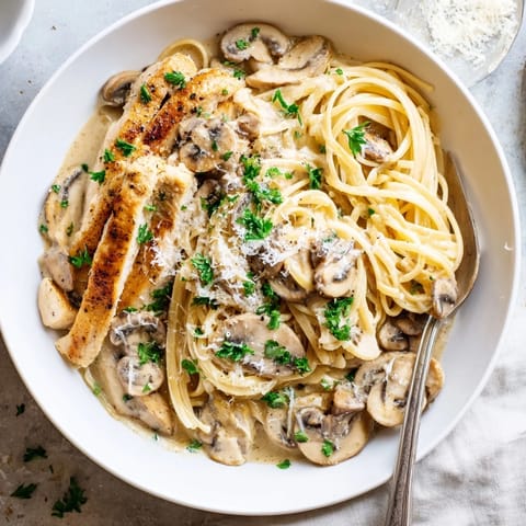 Creamy Mushroom Chicken Spaghettini features sautéed mushrooms and spinach tossed with pasta in a light Parmesan cream sauce.