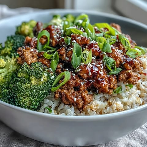 Sweet and Spicy Turkey Broccoli Bowls with steamed broccoli, saucy ground turkey, and fluffy brown rice topped with green onion.