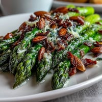 A vibrant platter of lemon butter asparagus with golden toasted almonds, perfect for spring celebrations.  